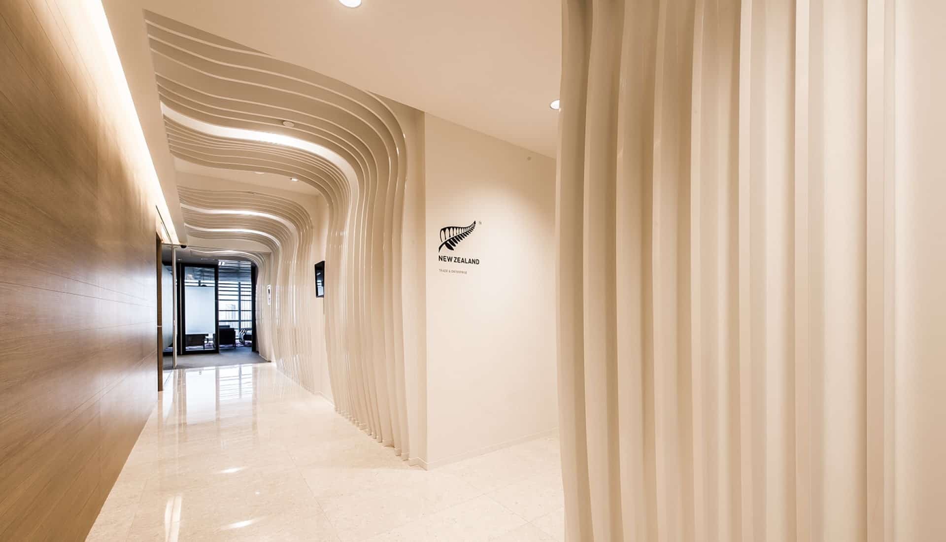 Ministry of Foreign Affairs and Trade office Singapore entrance design including white curved archways and New Zealand silver fern